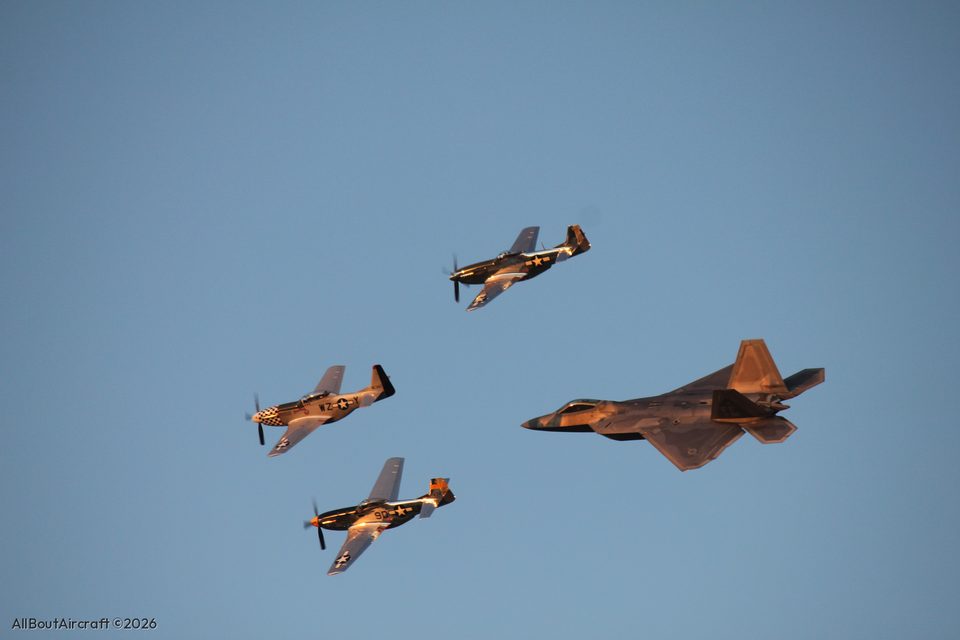 Three P-51s and an F-22 at dusk